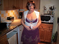 Mature with huge tits in kitchen.